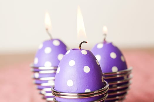 Close-up of purple dotted Easter egg candles