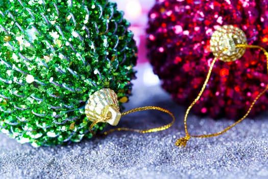 Close-up of sparkling green and red Christmas baubles