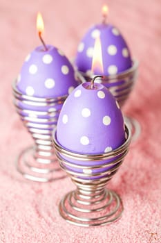 Close-up of purple dotted Easter egg candles