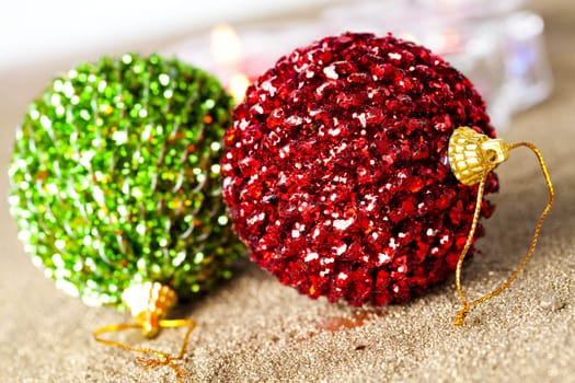 Close-up of sparkling Christmas baubles and candles