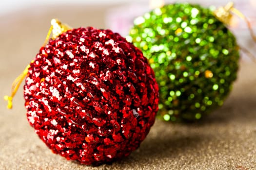 Close-up of sparkling green and red Christmas baubles