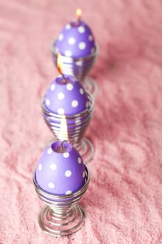 Close-up of purple dotted Easter egg candles
