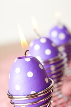 Close-up of purple dotted Easter egg candles