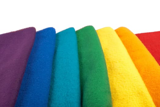 Colorful stack of scarfs in rainbow colored order. Isolated on white background