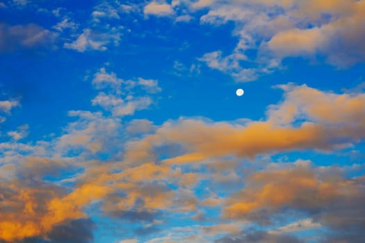 Morning sunrise with orange white clouds and a deep blue sky in the autumn.