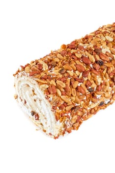 Nuts Swiss roll closeup isolated on a white background