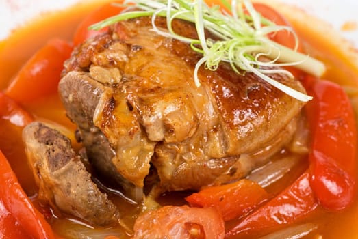 knuckle of veal baked with vegetables closeup