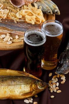 Beer and snacks set: chips, pistachio, shrimp and fish