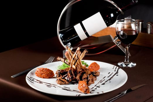 Roasted lamb chops with vegetables on decorated table