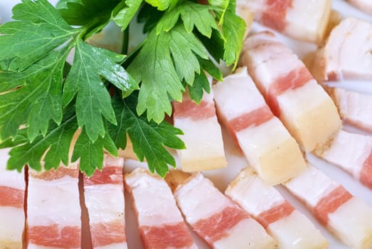 Sliced pig lard with greens closeup