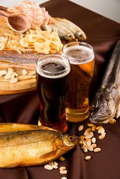 Beer and snacks set: chips, pistachio, shrimp and fish