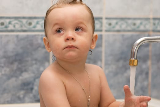 Baby bathes in the bath