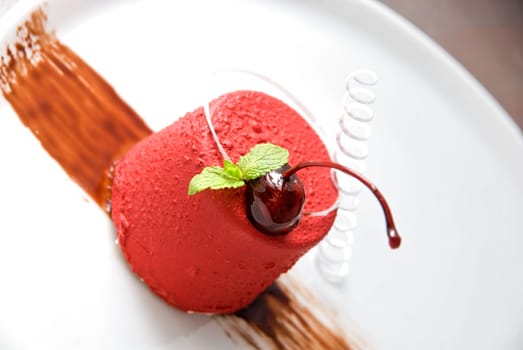 Tasty dessert of whipped cream, chocolate cherry, caramel and mint
