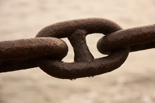 Macro shot of an old wet iron chain
