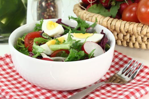 a white bowl of mixed salad
