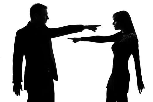 one caucasian couple man and woman pointing at each other expressing accusation in studio silhouette isolated on white background