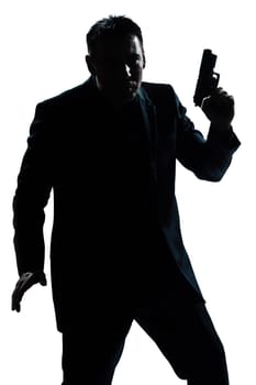 one caucasian spy criminal policeman detective man holding gun portrait silhouette in studio isolated white background