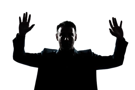 one caucasian man portrait silhouette hands up in studio isolated white background