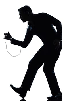 one caucasian man dancing happy listening to music full length silhouette in studio isolated white background