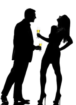 one caucasian couple man and woman driking flirting in studio silhouette isolated on white background