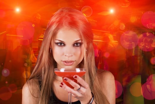 Girl with cocktail on dancing people background