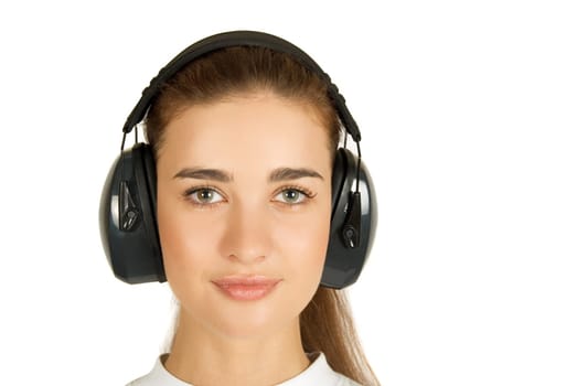 Girl at safety noise earphones on a white background