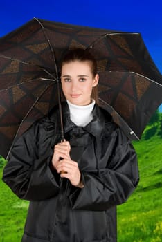 pretty brunette girl at black coat under umbrella