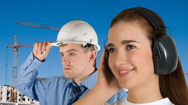 Portrait of young architects at in front of construction site, building and crane.