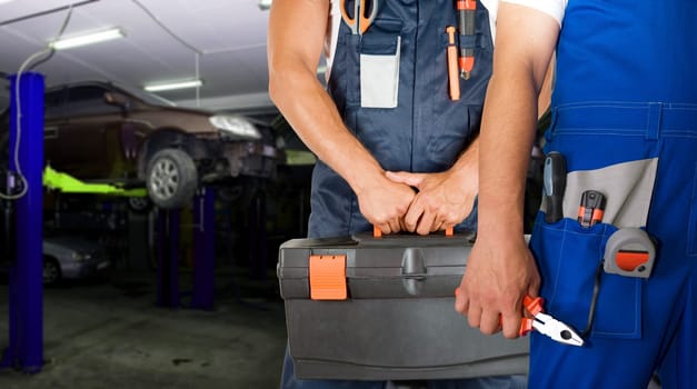 Auto mechanics closeup standing in his workshop