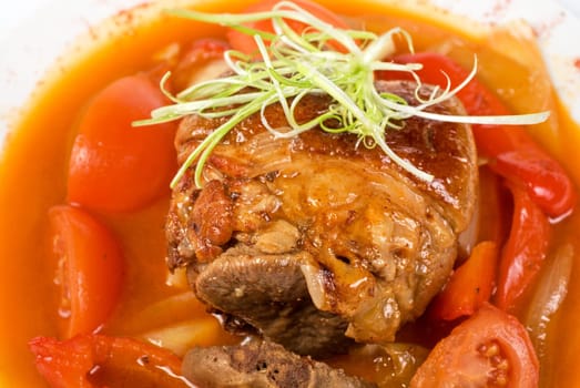 knuckle of veal baked with vegetables closeup