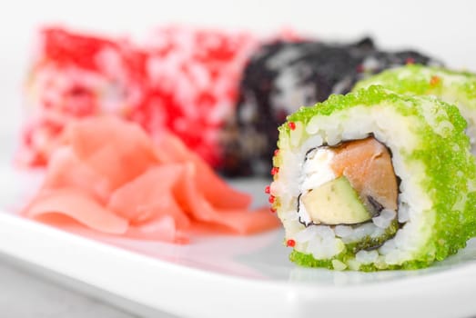 Sushi rolls made of salmon, avocado, flying fish roe (tobiko caviar) and philadelphia cheese