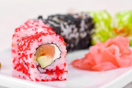 Sushi rolls made of salmon, avocado, flying fish roe (tobiko caviar) and philadelphia cheese