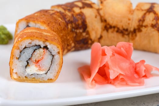 Sushi - made of crab meat, cheese, omelette outside