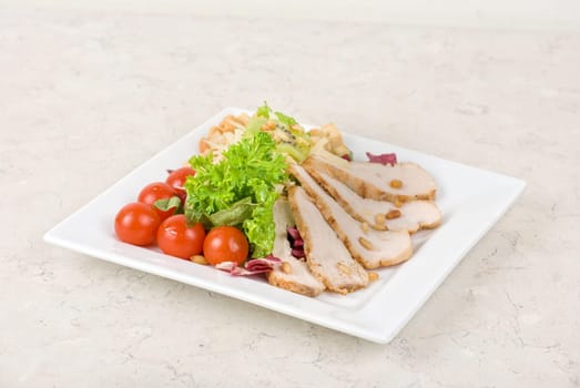 Tasty appetizer of meat, cherry tomato, greens and groundnut