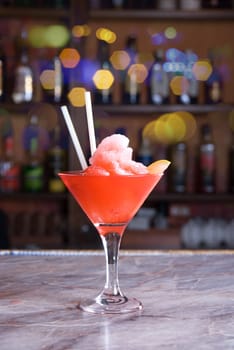 red frozen cocktail on the wooden bar
