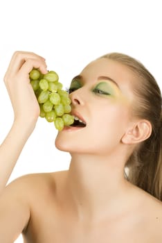 Pretty young woman with grape on the white background