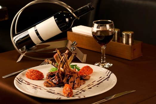 Roasted lamb chops with vegetables on decorated table