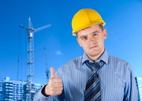 Engineer at white helmet on building background