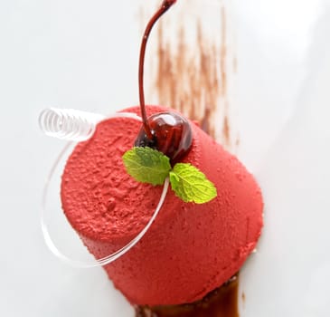 Tasty dessert of whipped cream, chocolate cherry, caramel and mint