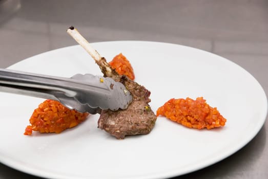 roasted lamb meat at metal plate