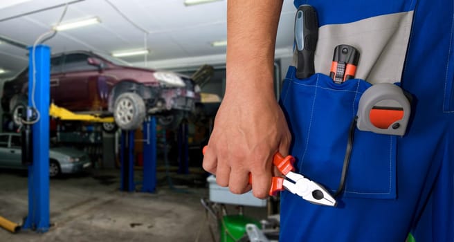 Auto mechanic closeup standing in his workshop
