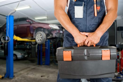 Auto mechanics closeup standing in his workshop
