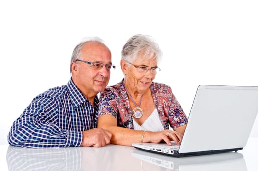 Senior man and woman using a computer laptop