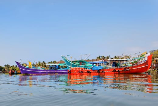 horizontal landscape of colorful fishing boats moored at Kochin backwaters Kerala India on the way to boat races held annually at North Paravoor Gothuruth, Kerala