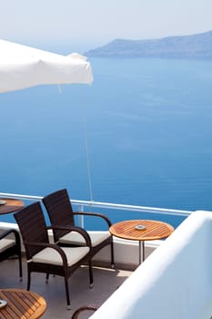 Tables and chairs on a patio in Thira, Santorini, Greece