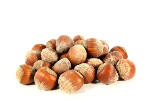 a handful of hazelnuts against a white background