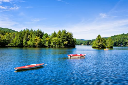 A lake in the mountains with small boats