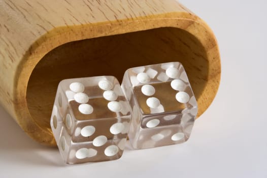 Dice showing double sixes in front of a shaker