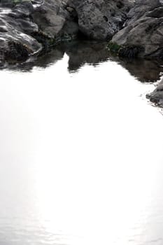 rocks on a beach in co kerry ireland on a crisp clear day