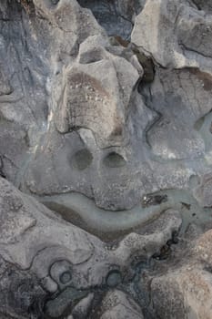 a smiley face shape on a rock pool surface